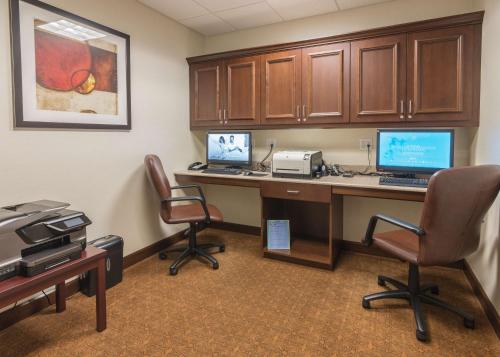 an office with a desk with two computers on it at Hampton Inn Bangor in Bangor