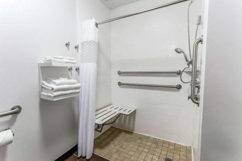 a bathroom with a shower with a bench in it at Hampton Inn Biloxi-Ocean Springs in Biloxi
