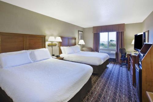 a hotel room with two beds and a television at Hampton Inn Pittsburgh Area-Beaver Valley-Center Township in Monaca
