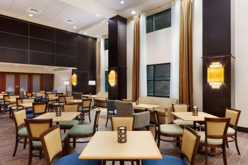 a dining room with tables and chairs at Hampton Inn and Suites Camp Springs in Camp Springs
