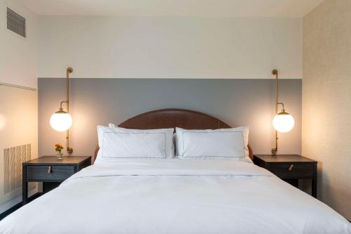 a bedroom with a large white bed with two night stands at Hotel Canandaigua, Tapestry Collection By Hilton in Canandaigua