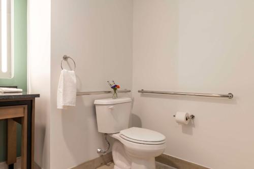 a bathroom with a white toilet and a towel at Hotel Canandaigua, Tapestry Collection By Hilton in Canandaigua