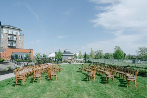 a row of chairs sitting in the grass at a wedding at Hotel Canandaigua, Tapestry Collection By Hilton in Canandaigua