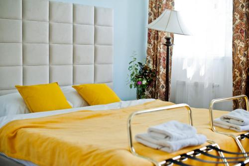 a bedroom with a bed with towels on it at Kuźnia Pałacowa in Korczew