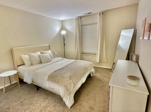 a bedroom with a large bed and a window at Cozy Apartment in Frederick in Frederick