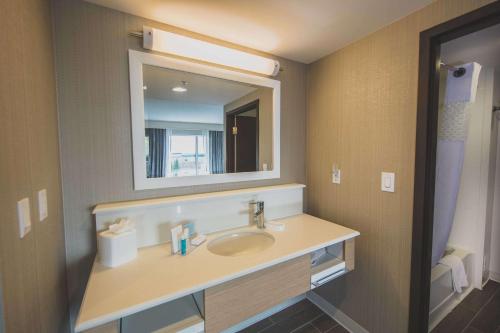 a bathroom with a sink and a mirror at Hampton Inn & Suites by Hilton Bolton in Bolton