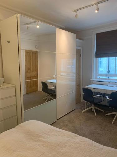 sypialnia z lustrem, stołem i krzesłami w obiekcie St Martins w Londynie