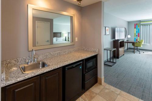 a bathroom with a sink and a mirror at Hampton Inn Minneapolis/Shakopee in Shakopee