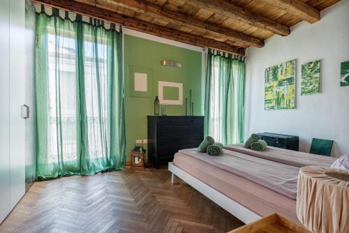 a bedroom with a large bed and large windows at Lovely apartment In Vicenza in Vicenza