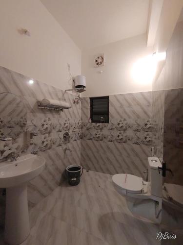 a bathroom with a sink and a toilet at TIERRA HOTEL CUM RESTAURANT in Kāziranga