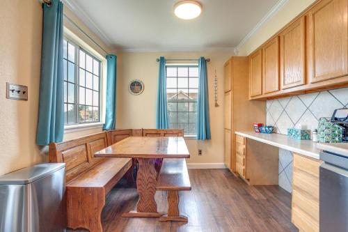 a kitchen with a wooden table in the middle at 11 Mi to Denver Pet-Friendly Home in Thornton! in Thornton