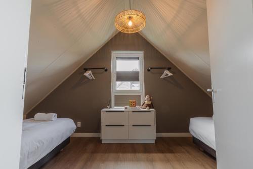 a room with two beds and a sink in a attic at Hip in Sint Maarten by Droomvilla in Sint Maarten