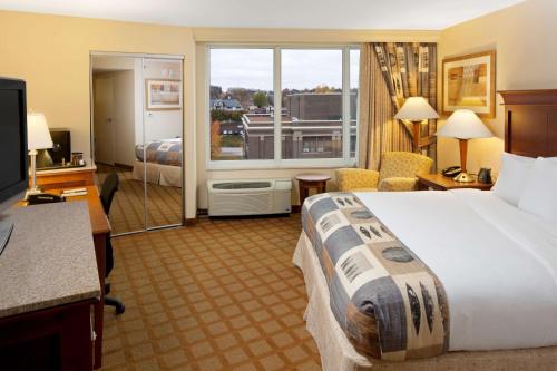 a hotel room with a bed and a large window at DoubleTree by Hilton Jefferson City in Jefferson City