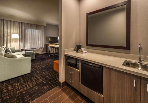 a hotel room with a television and a living room at Hampton Inn & Suites - Reno West, NV in Reno