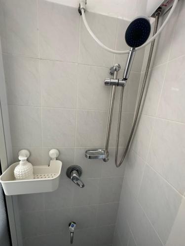 a bathroom with a shower with a shower head at Sea breeze in Bat Yam