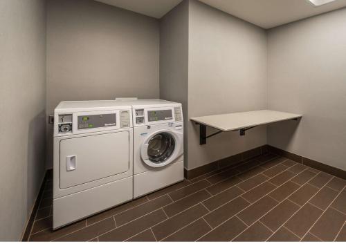 a laundry room with a washing machine and a table at Hampton Inn & Suites - Reno West, NV in Reno