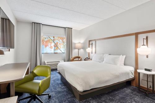 a hotel room with a bed and a desk and a chair at Fairfield Inn & Suites by Marriott Hickory in Hickory