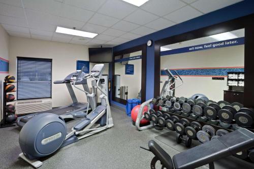 a gym with two treadmills and weights at Hampton Inn Williamsport in Williamsport
