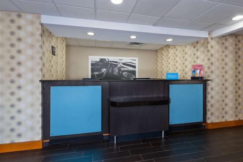 a desk with two blue screens in a room at Hampton Inn Marysville in Marysville