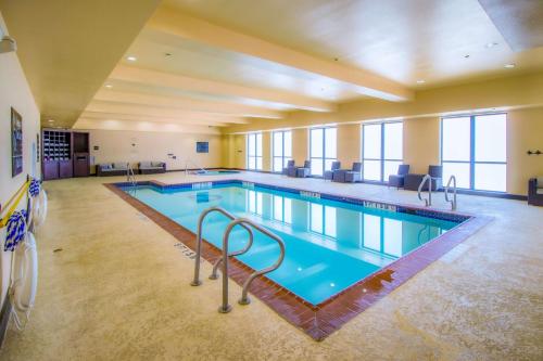 a large swimming pool in a large building at Hampton Inn & Suites Bastrop in Bastrop