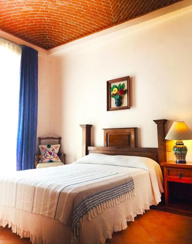 a bedroom with a large bed and a window at Hotel Lunata - 5th Avenue in Playa del Carmen