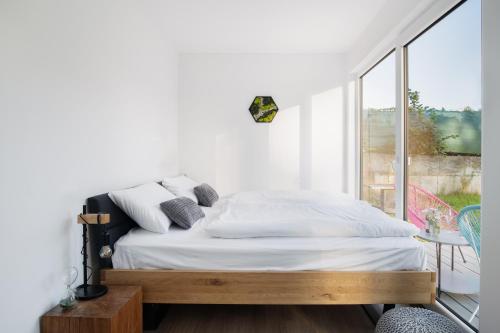 a bedroom with a bed and a large window at CONTAINER in Děčín