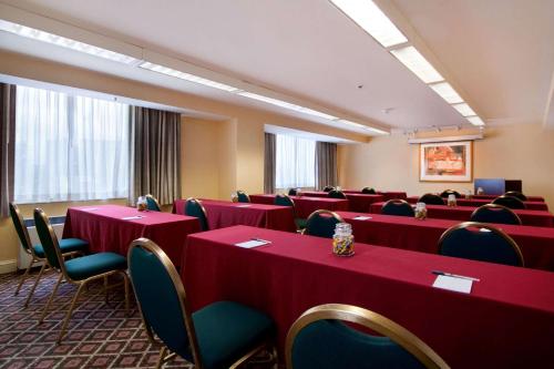 a conference room with red tables and chairs at Homewood Suites by Hilton Falls Church in Merrifield