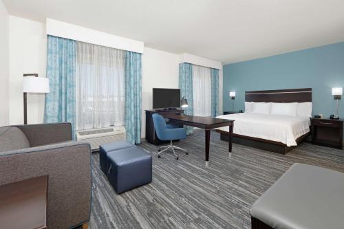 a hotel room with a bed and a desk at Hampton Inn & Suites Childress in Childress