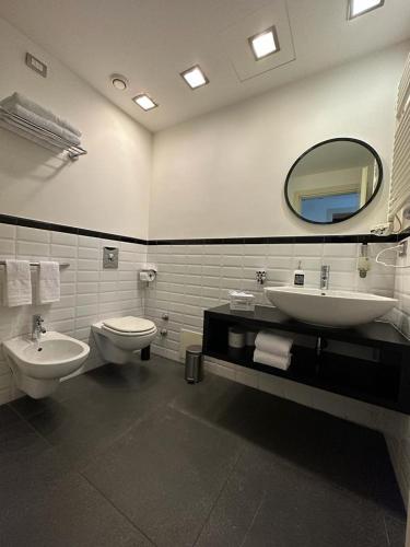 a bathroom with two sinks and a mirror at Qatar Apartment in Cosenza