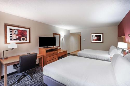 a hotel room with two beds and a desk with a computer at Hampton Inn Aiken in Aiken