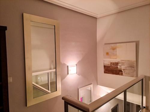 a mirror on the wall next to a stairway at Modern Townhouse Ocean Front in Adeje