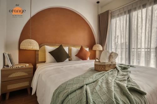 a bedroom with a large bed and a large window at iRest Orange Tay Ho Lakeside Apartment in Hanoi