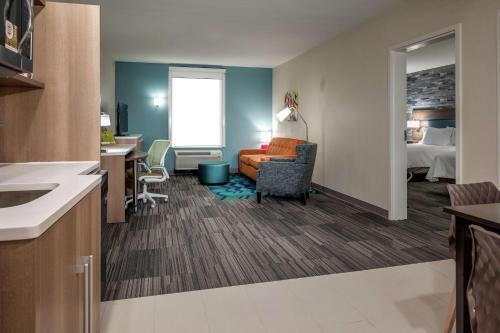 a hotel room with a kitchen and a bedroom at Home2 Suites By Hilton Dayton Centerville in Centerville