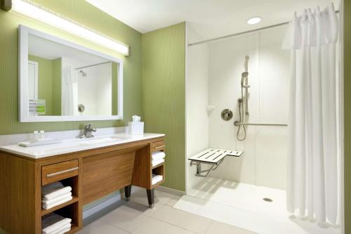 a bathroom with a sink and a shower at Home2 Suites by Hilton Saratoga Malta in Malta