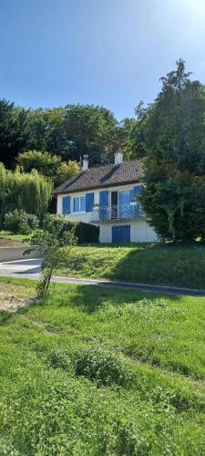 a white house with blue windows and a road at Gîte Du Bas Bagneux - Classé 3 Etoiles- 9 kms du Zoo de Beauval in Mareuil-sur-Cher