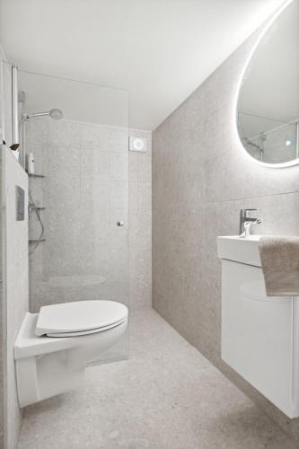 a white bathroom with a toilet and a sink at Apartment in Stavanger in Stavanger