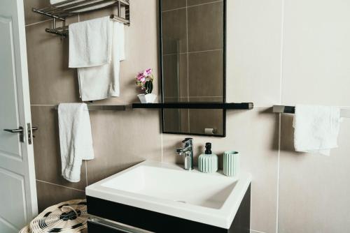 a bathroom with a white sink and a mirror at Sizakele Stays in Johannesburg