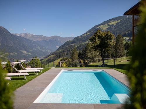 a swimming pool with a view of mountains at Natur Residence Kaiser Hans in Schenna