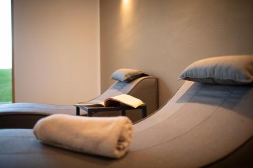a row of beds in a room with a table at Natur Residence Kaiser Hans in Schenna