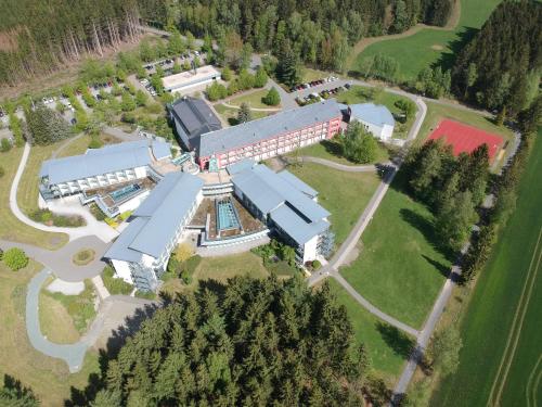an aerial view of a large building with a pool at Green Night Hotel in Falkenstein