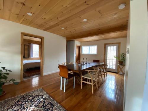 a dining room with a table and chairs at Mountain Farmhouse (The Lorca, Catskills) in Shandaken