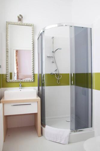 a bathroom with a glass shower and a sink at Kuźnia Pałacowa in Korczew