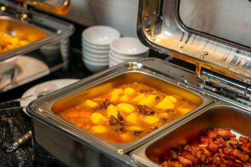 a container of food with vegetables and other food items at MAY DE VILLE Lakeside Hotel in Hanoi