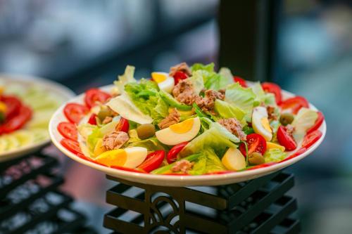 a salad with meat and vegetables on a plate at MAY DE VILLE Lakeside Hotel in Hanoi