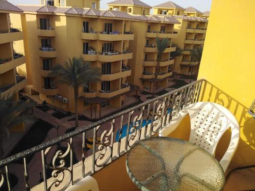 a balcony with a table and chairs and buildings at Hurghada British compound in Hurghada