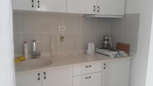 a kitchen with a sink and a counter top at Chiyanno's Inn in Dalyanköy