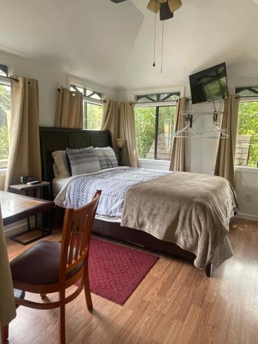 Creekside Fantasy Inn في هدسون: غرفة نوم بسرير وطاولة وكرسي