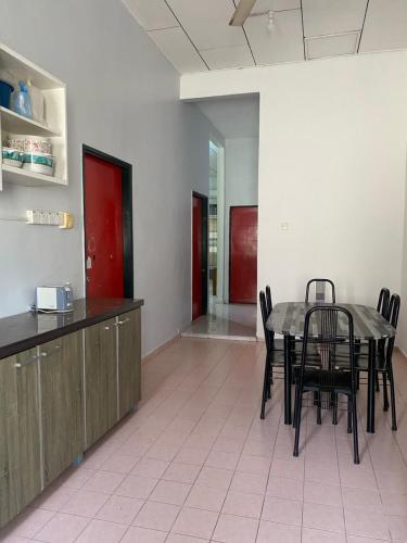 a dining room with a table and some chairs at Best Homestay in Kuala Rompin