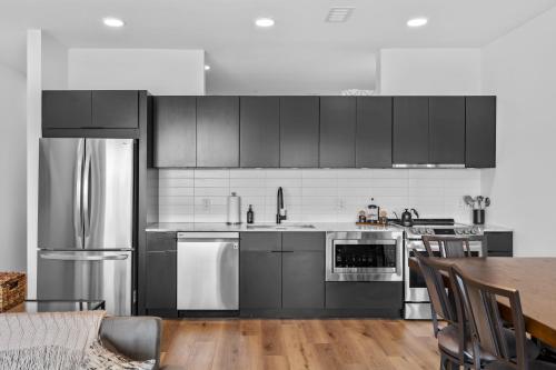 a kitchen with black cabinets and stainless steel appliances at River View, Balcony, Germantown, Central, Elevator in Nashville