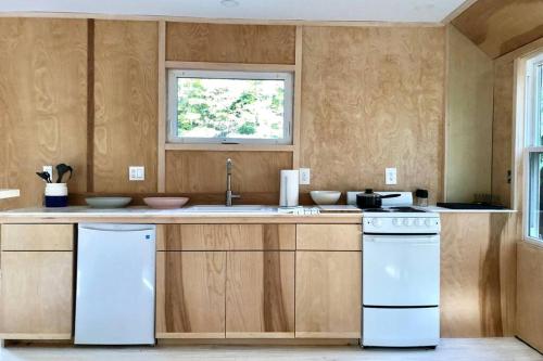 a kitchen with a white stove and a sink at Modern Cottage Two (The Lorca, Catskills) in Shandaken